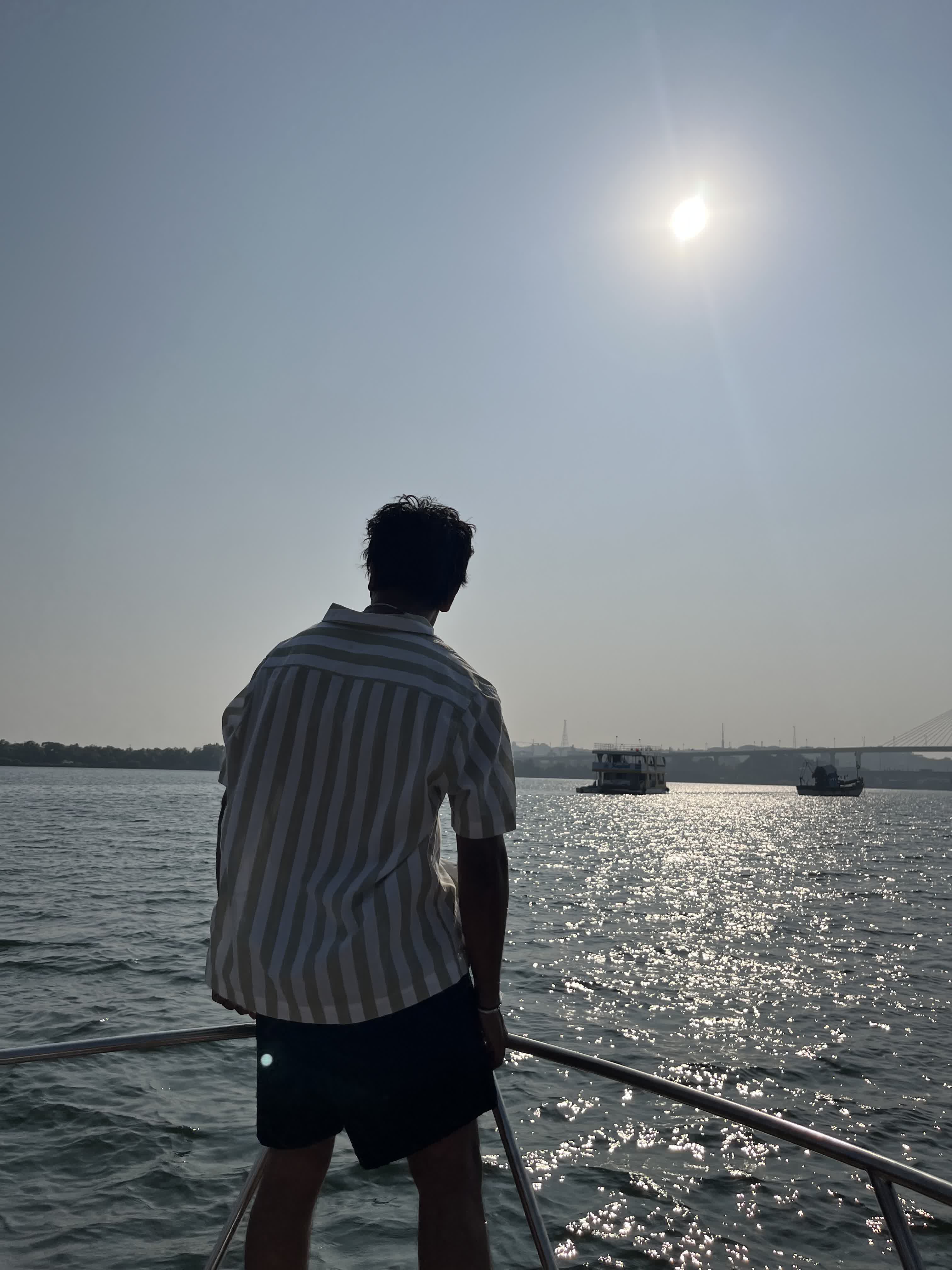 Looking out over the water from the bow of a boat in the sun