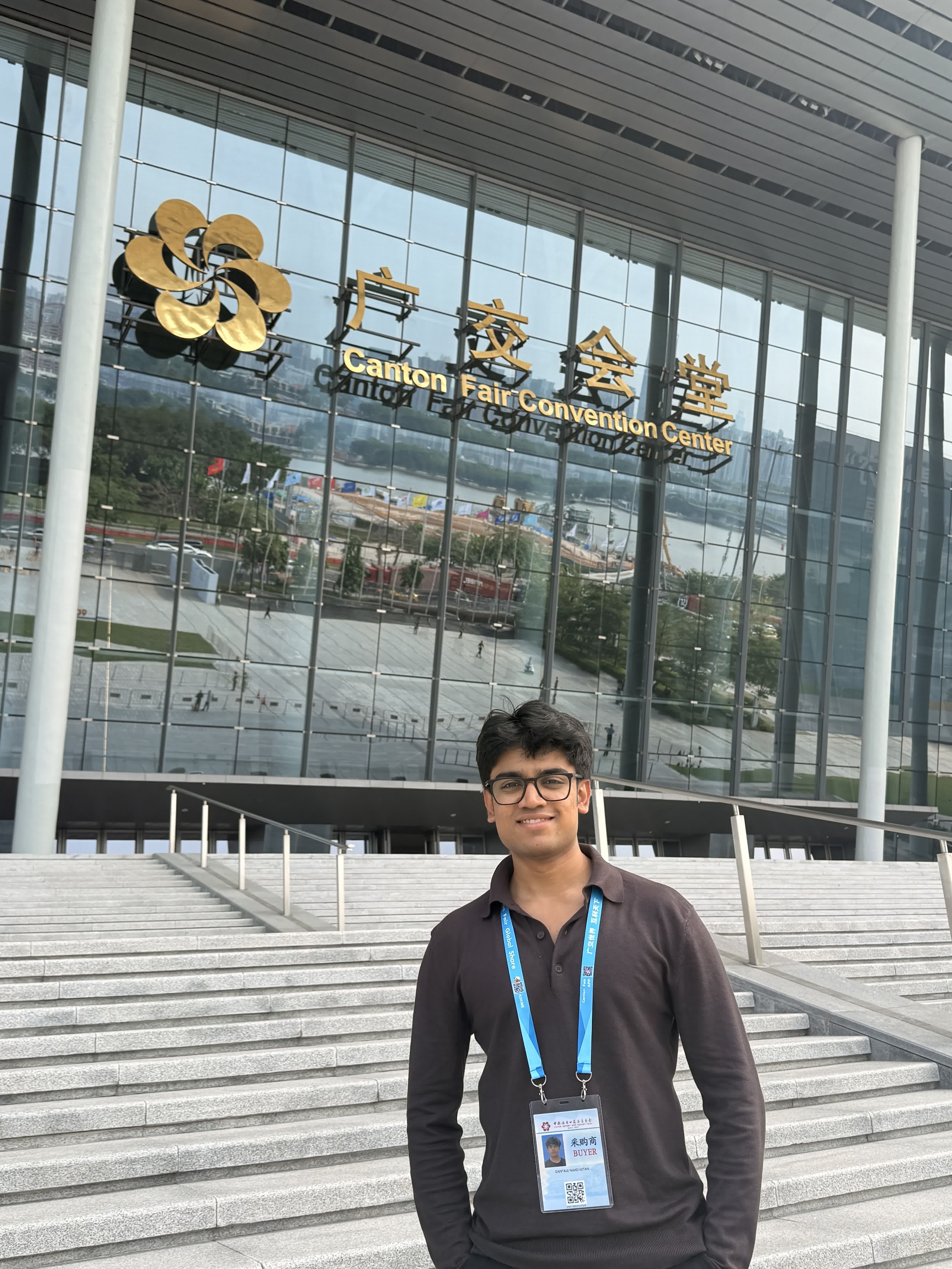 Standing in front of the Canton Fair Convention Center with my exhibitor badge