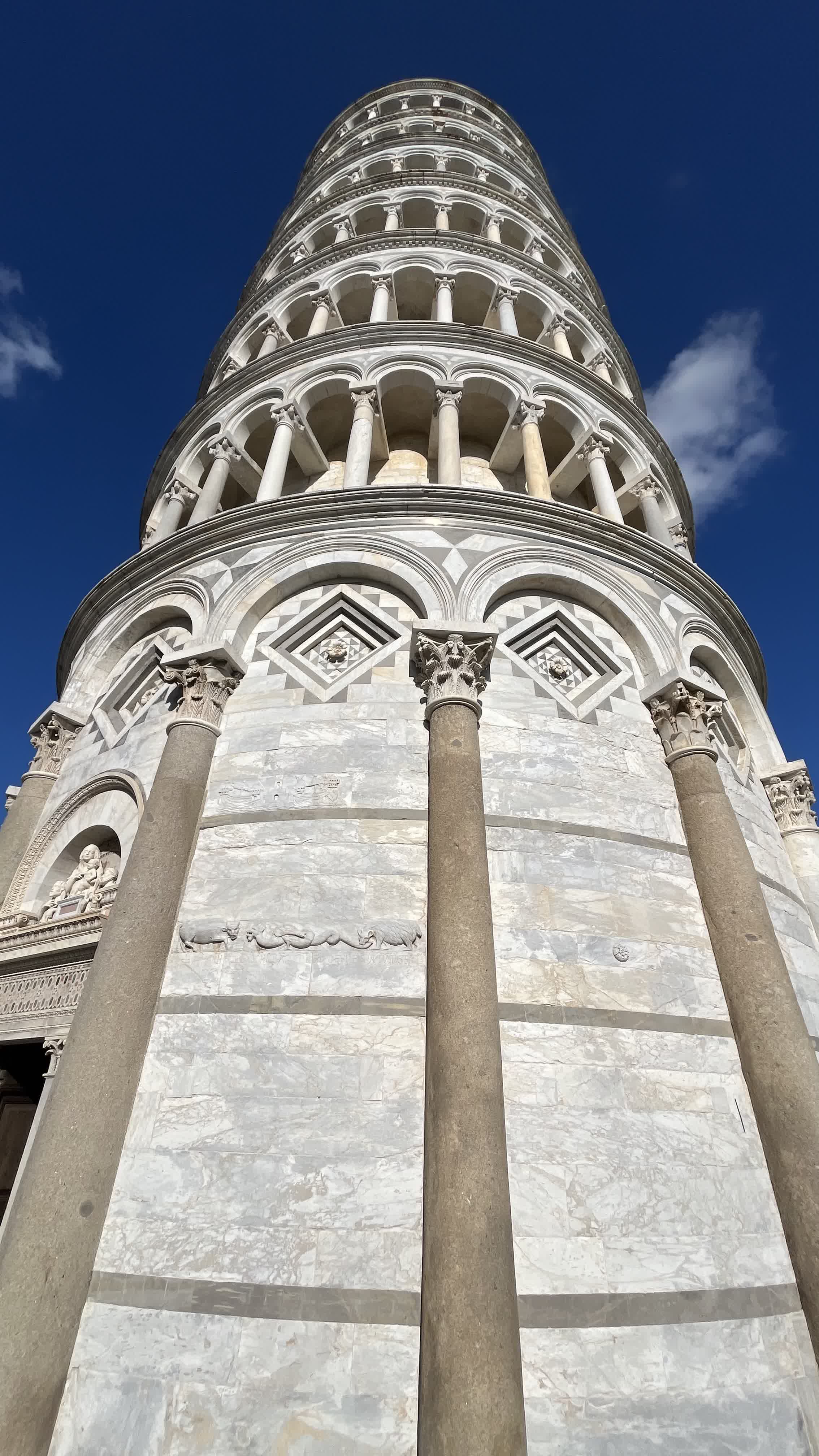 Looking straight up the marble columns of the Leaning Tower of Pisa