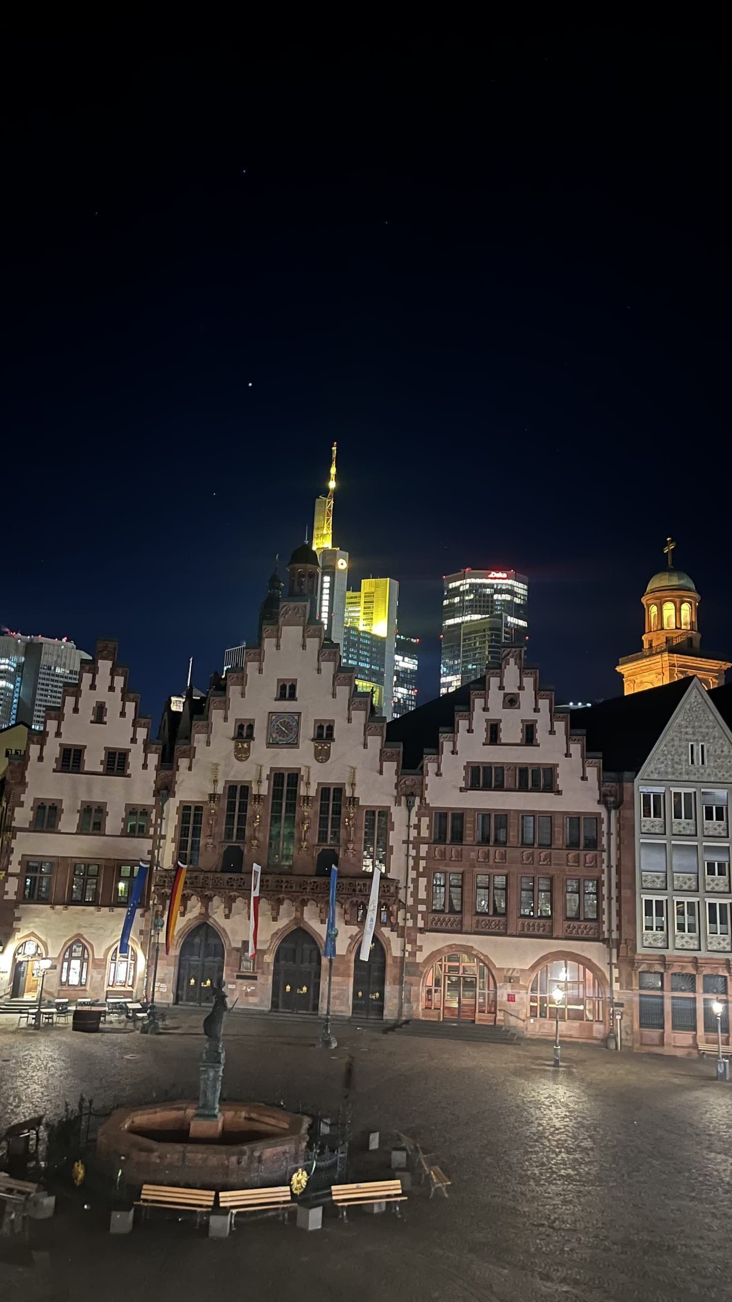 The Römerberg square at night with the lit Frankfurt banking skyline behind the old town hall